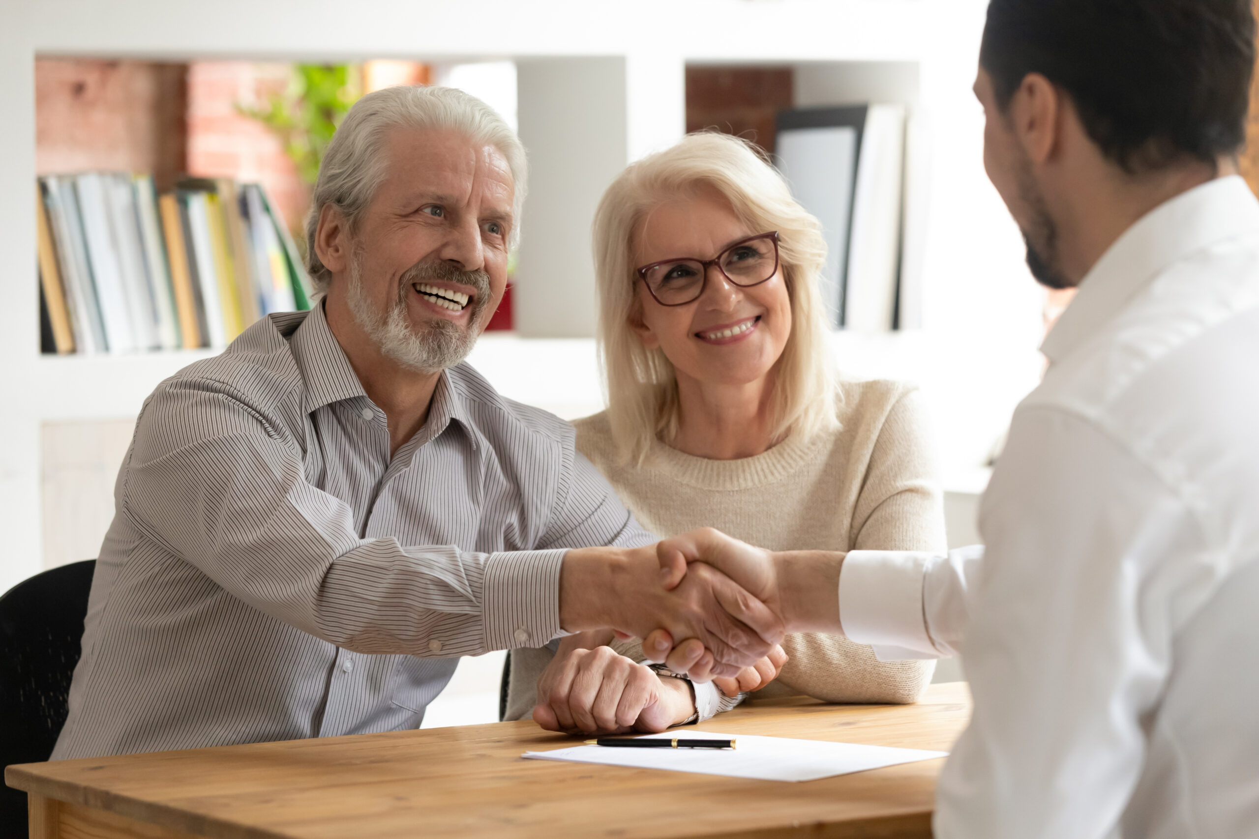Happy senior old family couple clients make financial insurance estate