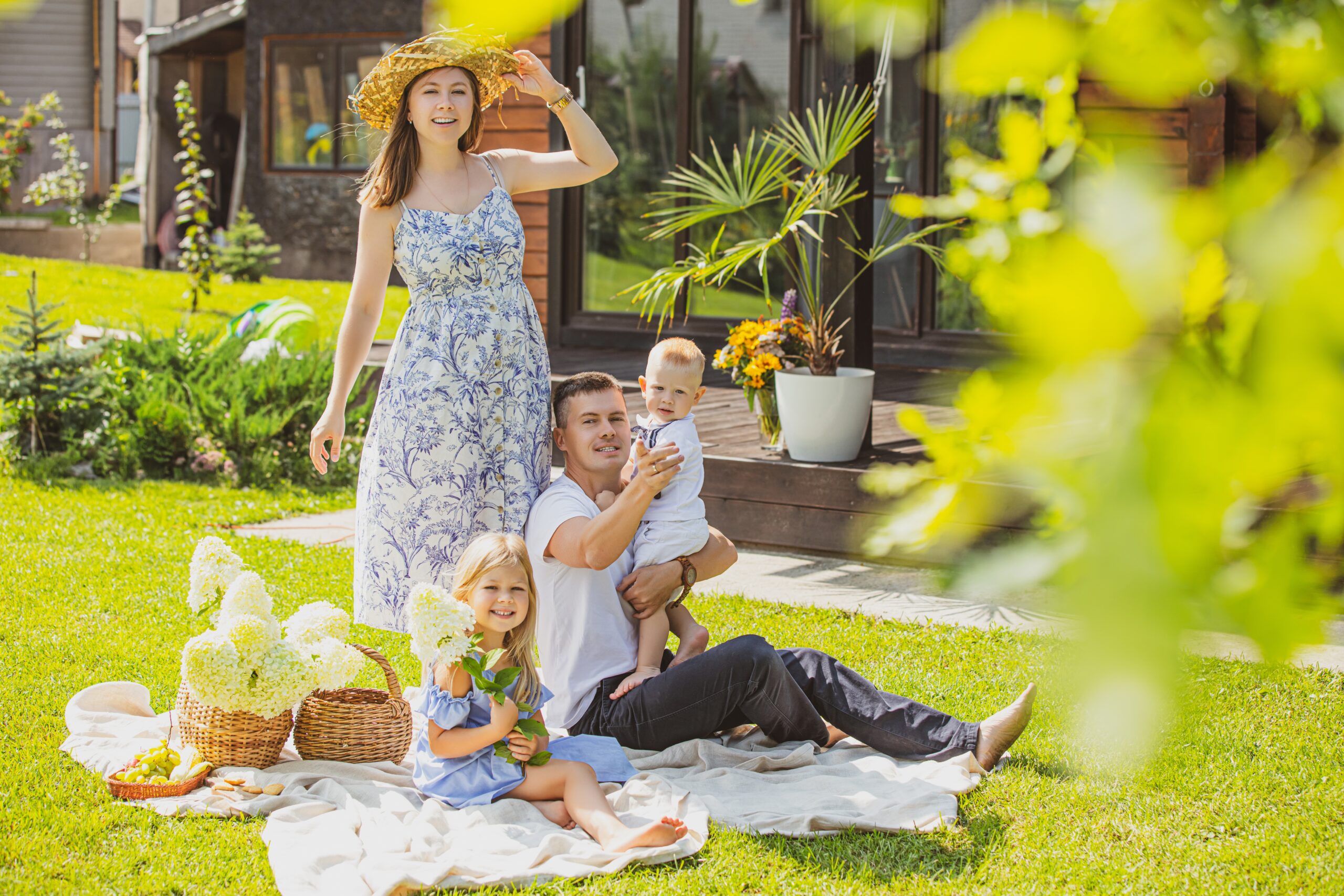 A Family Happily Relaxing Together in Front of Their House